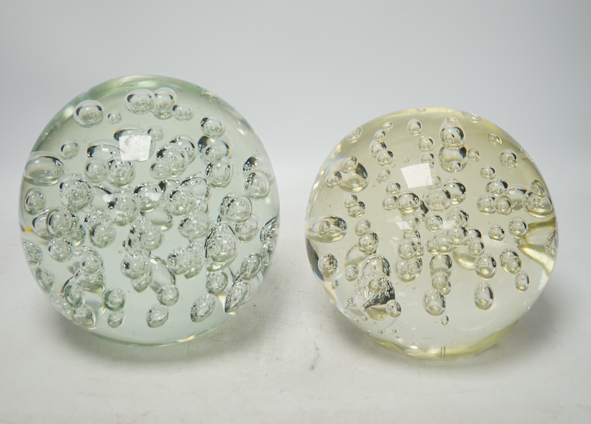 Two large glass bubble included door stops, 18cm. Condition - fair